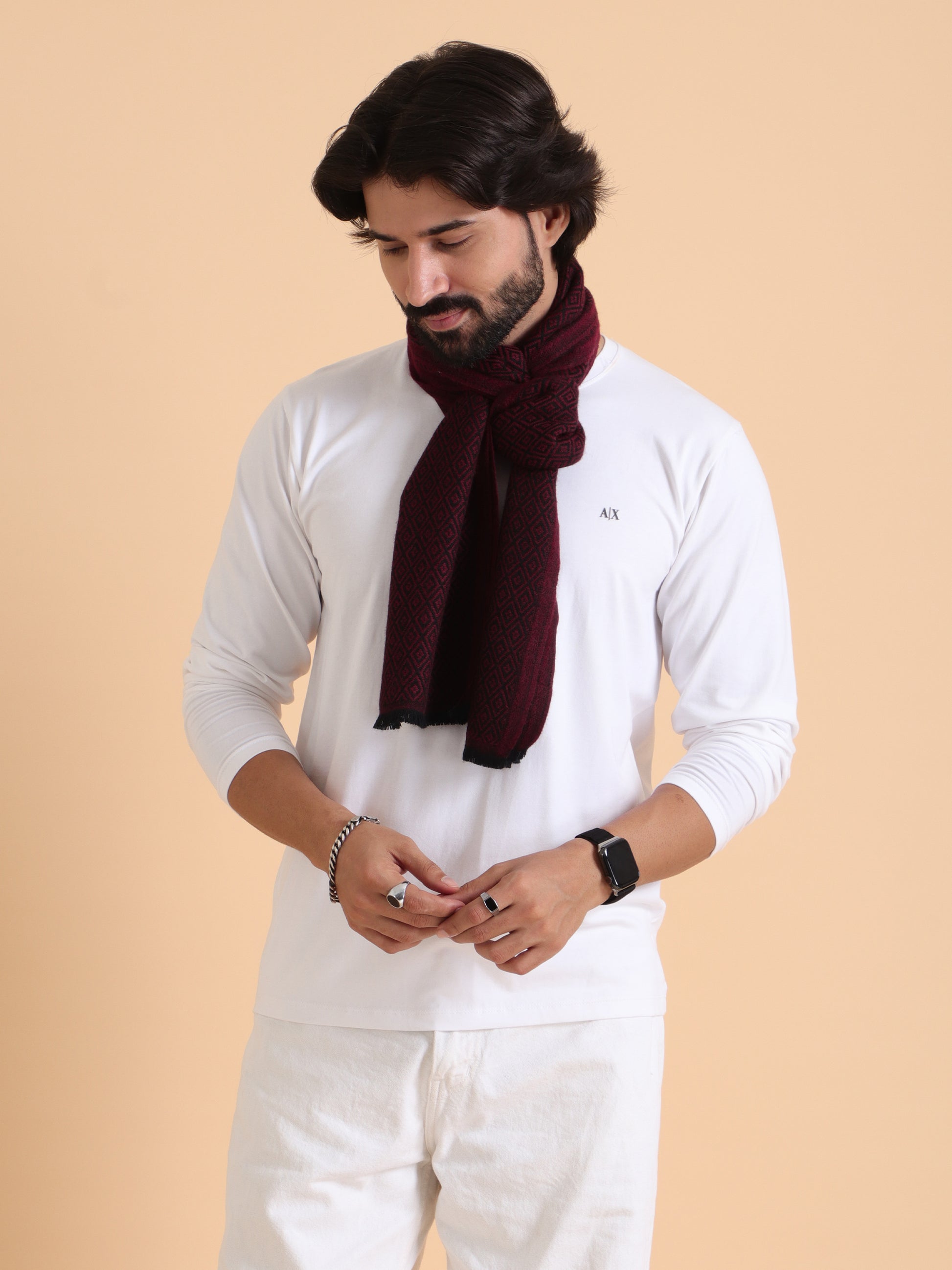 A luxury scarf in navy blue and brown checkered pattern with a geometric design 